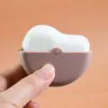 Portable makeup brush with white bristles and brown shell for blending foundation. - Brown And White