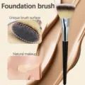 Flat foundation brush detail view showing soft dense bristles and natural liquid makeup effect. - Tricolor Fur / Black