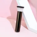 Detailed shot of a soft bristle makeup brush with a sleek brown handle for precise contouring. - Blush Brush-Flat