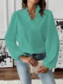 Details of green long sleeve V-neck ruffle trim blouse showcasing cuff and fabric texture. - S / Green