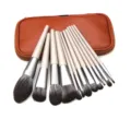 Detailed view of a versatile 12-piece makeup brush set with elegant handles and storage pouch. - With Brown Leather Pouch / 12 Pieces / Champagne