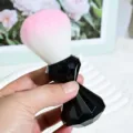 Detailed view of soft bristle makeup brush with black diamond handle for blush and powder. - Black Handle Pink White Bristles