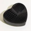 Tappetino pulisci pennelli trucco in silicone nero a cuore, accessorio pratico per la pulizia. - Nero