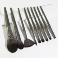 9-piece makeup brush set with dark green handles and soft bristles for precise application. - Teal Green