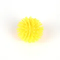 Detailed view of yellow mini spiky squeeze massage stress relief toy ball close up. - Yellow