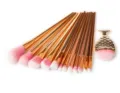 Detailed view of mermaid makeup brush set with gold handles and soft pink gradient bristles. - 12Pcs Gold Style