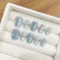 Handmade blue cat-eye press-on nails with crystal heart charms, reusable false nail art set. - Extra Small (XS) / Blue-Grey Cat Eye Heart Extra Short Coffin Style (1719) / Blue Gray