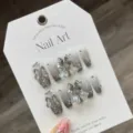 Handmade press-on nails set with silver gradient glitter, bows, and sparkling crystal rhinestones. - L / Silver Glitter Cat Eye Bow Rhinestone (896-Medium Coffin)