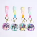 Cute mini water game console keychain with doll figures, colorful silicone strap, and metal rings. - Big Head Doll Water Game Keychain / 6.3x7.2x2.5cm