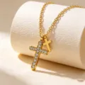 Detailed shot of double cross pendant necklace featuring sparkling rhinestones on gold chain. - Gold