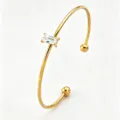 Gold open cuff bracelet featuring a rectangular cubic zirconia and cute ball ends. - Gold Rectangle Open Bangle (RT234SZ)