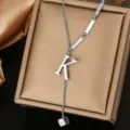 Close-up detail of stainless steel letter K Y-necklace pendant, elegant metallic texture. - Letter K Style (WY006-1-K)