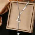 Detailed shot of a stylish silver titanium steel letter L pendant necklace with unique bar links. - Letter L Style (WY006-1-L)