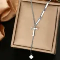 Close-up detail of stainless steel letter T pendant necklace, delicate chain and metallic finish. - Letter T Style (WY006-1-T)