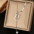 Close up of a silver stainless steel letter U pendant lariat necklace with bar links and cube. - Letter U Style (WY006-1-U)
