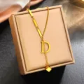 Stainless steel 18k gold plated letter D necklace pendant on chic beige jewelry box display. - Letter D (WY006SL) / Gold