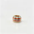 Close-up detail of a colorful striped enamel large-hole DIY charm bead for jewelry making. - M06