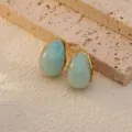 Stainless steel teardrop earrings with blue marble texture and gold rim for women detail shot. - Sky Blue