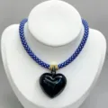 Detailed view of blue white braided rope necklace with glossy black heart pendant and gold rings. - B02 Finished Necklace / Blue and White Cord with Black Heart