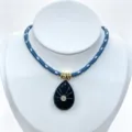 Blue braided rope necklace featuring a carved dark teardrop crystal pendant with sparkling stone. - Pendant With Chain / India Agate
