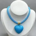 Detailed view of fashionable blue braided rope necklace with glossy heart pendant for DIY jewelry. - B07 Finished Necklace / Blue and White Cord with Bright Blue Heart