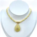 Detailed shot of a yellow braided rope necklace featuring a teardrop crystal pendant. - Pendant With Chain / Yellow
