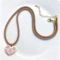 Chic beige woven rope necklace with a white and red heart pendant, gold-tone metal clasp. - Khaki Necklace Heart Style (C02-7)