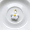 Close-up of white enamel flower charm pendant with yellow center and gold ring, DIY jewelry. - Pendant Only (No Chain) / White