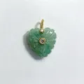 Close-up detail of green carved heart crystal pendant with gold bail and inset zircon stones. - Amazonite Pendant Only