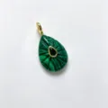 Exquisite teardrop malachite pendant with gold trim and central green gemstone. - Malachite Green