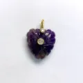 Close-up of a carved purple crystal heart pendant with gold bail and inlaid zircon stones. - Amethyst Single Pendant