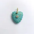 Detailed close-up view of carved turquoise heart pendant with gold bail and crystal stones. - Synthetic Turquoise Pendant Only