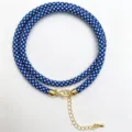 Blue and white braided rope necklace detail showcasing the gold clasp and extension chain. - A-03