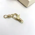 Close-up detail of gold-plated micro-pave zirconia clasp connector for DIY jewelry making. - Gold