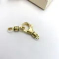 Close-up detail of gold-plated brass DIY jewelry clasp connector with green micro pave stones. - Gold