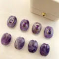 Natural stone spacer beads detail showing purple oval beads with gold-rimmed purple zircon. - A05