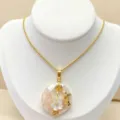 Exquisite natural abalone shell pendant necklace featuring intricate gold floral design detail. - G10