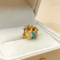 Close-up detail view of a colorful baguette zirconia wheel charm, brilliant crystal sparkle. - Colorful