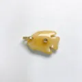 Close-up detail of a carved yellow stone tropical fish pendant with sparkling zircon insets. - Pendant Only / Topaz