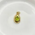 Close up detail of the teardrop green gemstone pendant, featuring a polished gold finish. - Pendant Only (Without Chain) / Light Green