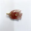 Close-up detail of carved crystal fish pendant with sparkling zirconia and gold metal trim. - Pendant Only / Strawberry Quartz
