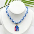 Detailed view of the colorful house enamel pendant necklace with blue and white braided rope. - Pendant With Chain (E02-2)