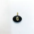 Elegant oval carved black stone pendant featuring a central zircon in gold tone. Detail shot. - Pendant Only (Without Chain) / Black Agate