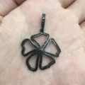 Detailed view of a black gunmetal floral pendant with pavé stones, exquisite jewelry detail. - A2-Five-Petal Heart Hollow Style / Gunmetal