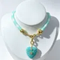 Turquoise carved heart pendant necklace with woven cord and gold-plated hardware details. - Turquoise Pendant Necklace