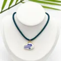 Detail view of gold-plated enamel white cloud pendant necklace with dark green rope chain. - K02-10 (Pendant with Chain as Pictured)