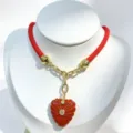 Red cord necklace with carved heart pendant, gold link hardware and inlaid zircon stones. - Red Pendant Necklace