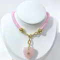 Exquisite pink crystal heart pendant necklace featuring gold hardware and pink rope style. - Rose Quartz Pendant Necklace