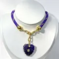 Purple woven cord necklace with carved heart crystal pendant and gold metal links. - Purple Pendant Necklace