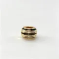 Closeup detail of gold-plated black white striped enamel large hole DIY charm bead accessory. - M07